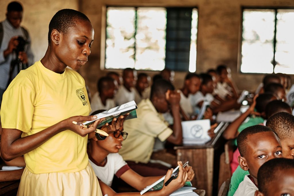 A facilitator leading a group of pupils