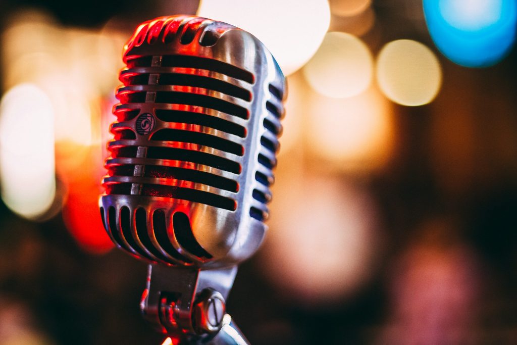 A microphone under warm stage light